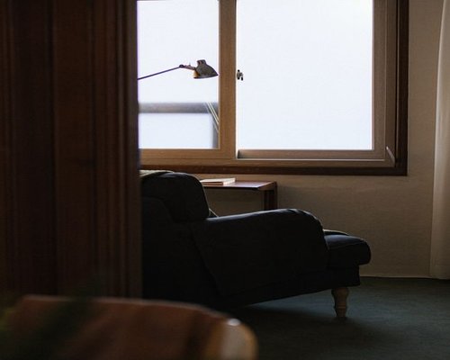 A quiet reading corner with a comfortable chair near a large window letting in natural light
