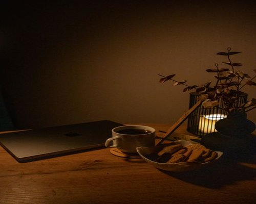 A relaxed evening atmosphere in a home with soft lighting and a closed laptop